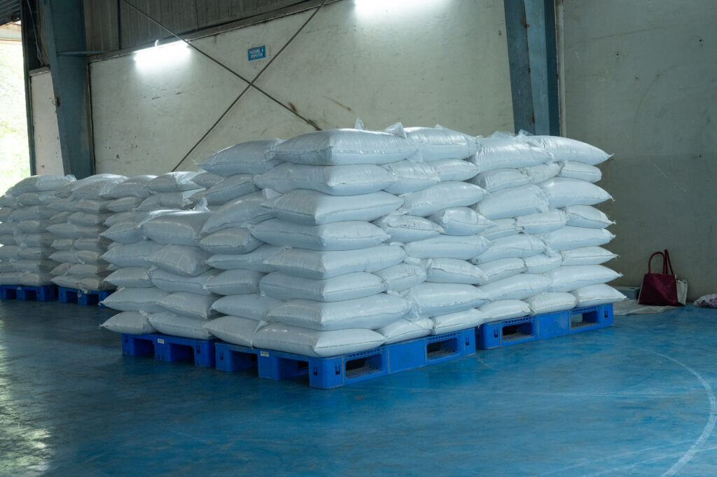 Bagged finished-product stock on pallets at the Quessentials Malur warehouse